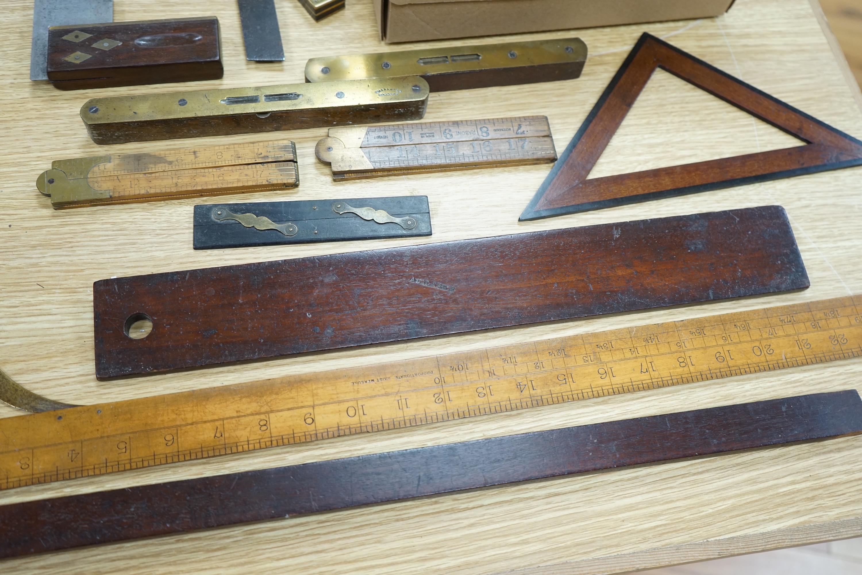 A collection of 19th and 20th century drawing instruments, including; levels, rulers, a set square etc. longest 79cm. Condition - variable, mostly fair to good